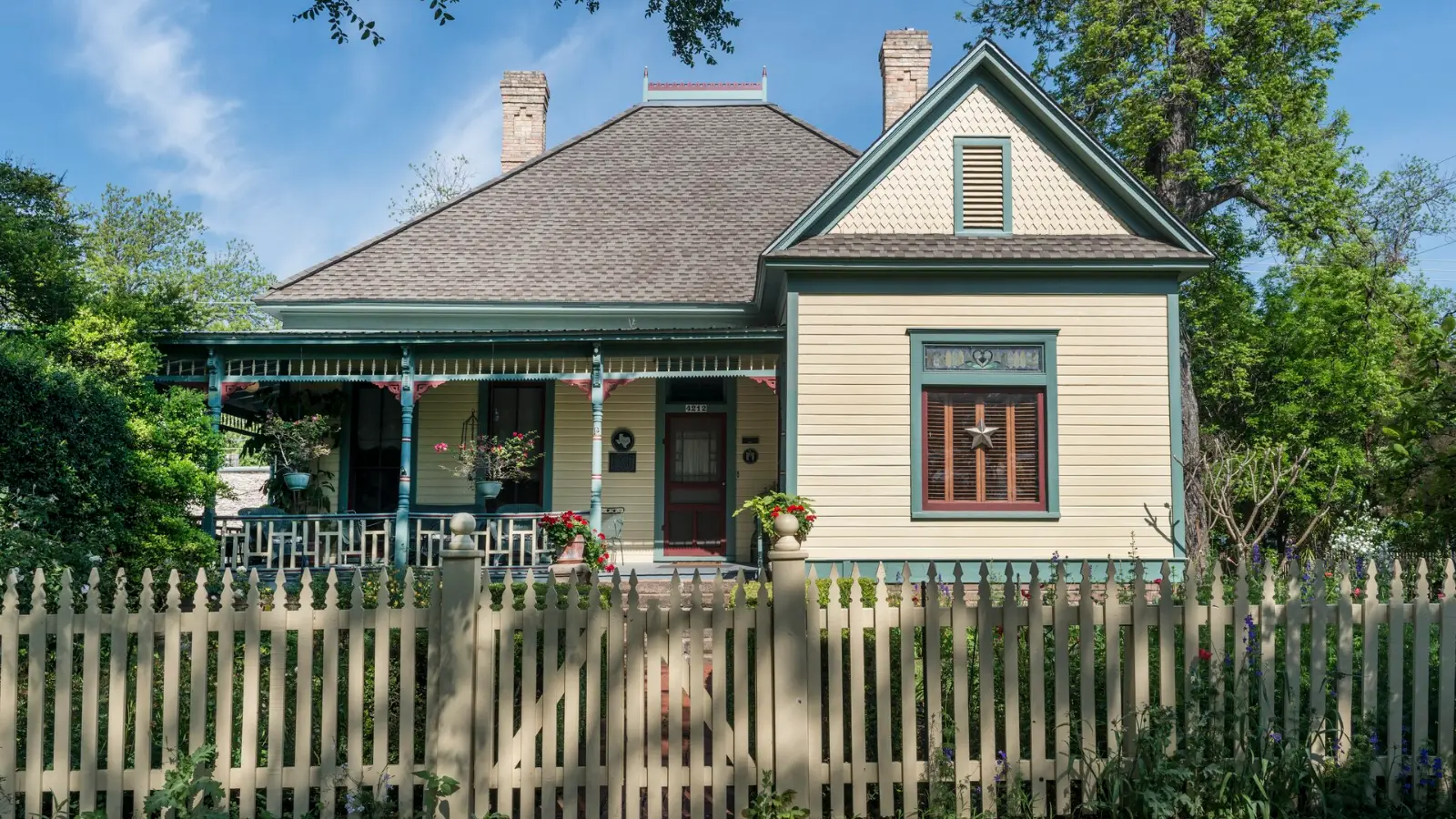An older cottage with a front porch and a picket fence in Austin, Texas